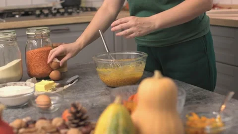 Adding eggs in dough cooking traditional pumpkin pie thanksgiving holiday meal Video stock 220792310