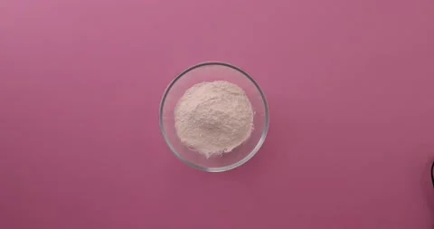 Adding eggs, flour, baking powder, and sugar to a glass bowl 1 Video stock 132147352