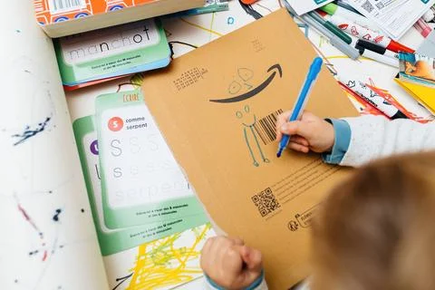 Adding Eyes to Amazon Logo: Overhead Creative View Stock Photos