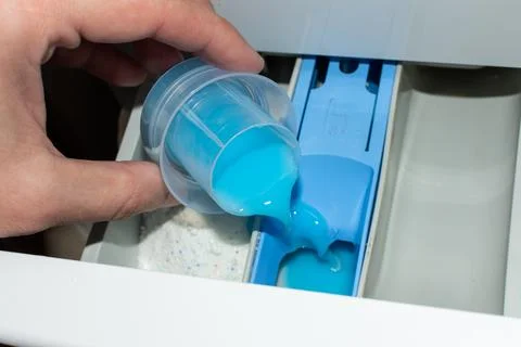 Adding fabric softener to the washing machine Stock Photos