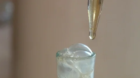 Adding a few drops of reagents to the flask. Stock Footage 127320915