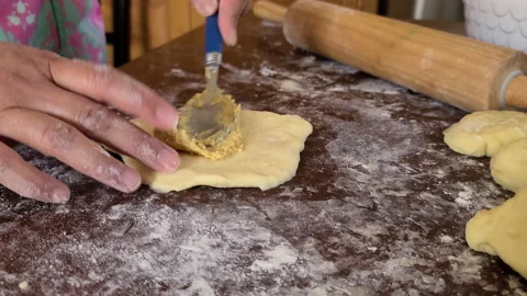 Adding filipino sweet, buttery paste filling of spanish bread filling. Stock Footage 131287724