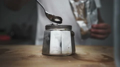 Adding filter coffee powder in mini espresso maker machine Stock Footage 164285689