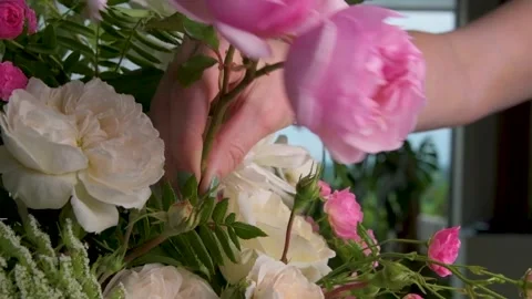 Adding final pink roses to giant flower display slow motion tracking shot Stock Footage 280123806