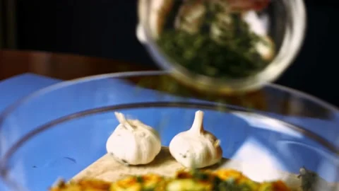 Adding finely chopped fresh parsley to roasted golden potatoes spiced with fried Stock Footage 151341613