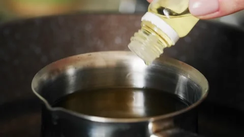 Adding flavoring to melted wax. Stock Footage 234181702
