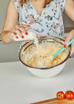 Adding flour and mixing batter Stock Photos