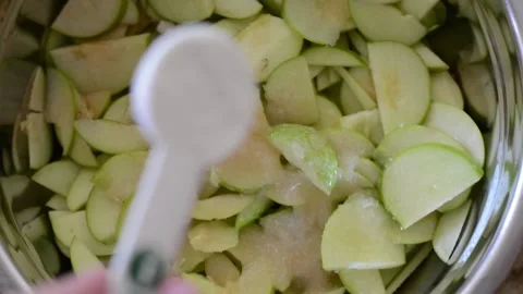 Adding Flour to Apple Wedges  Stock Footage 130354967
