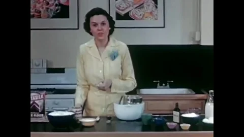 Adding flour, baking powder, sugar and butter to cake mix in this archival Stock Footage 74705311