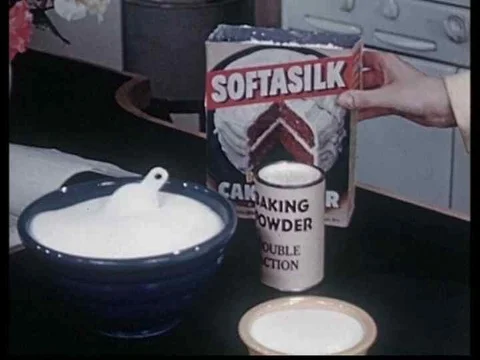 Adding flour, baking powder, sugar and butter to cake mix in this archival Stock Footage 75097775