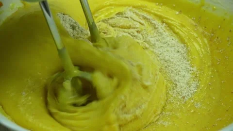 Adding flour to beaten eggs in the process of making cake via electric mixer Video stock 233518744