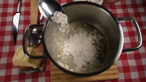 Adding flour to butter Stock Footage 238015596