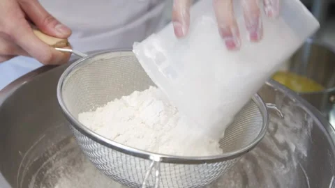 Adding flour into a container Stock-Footage 307339931
