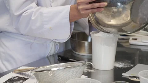Adding flour into a container Stock Footage 307339935