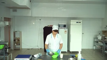 Adding flour to the dough. Chef hands pouring white flour to the dough in bowl. Stock Footage 85665681