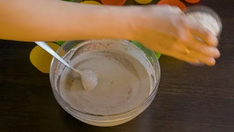 Adding flour to dough for cupcakes Stock Footage 86338571