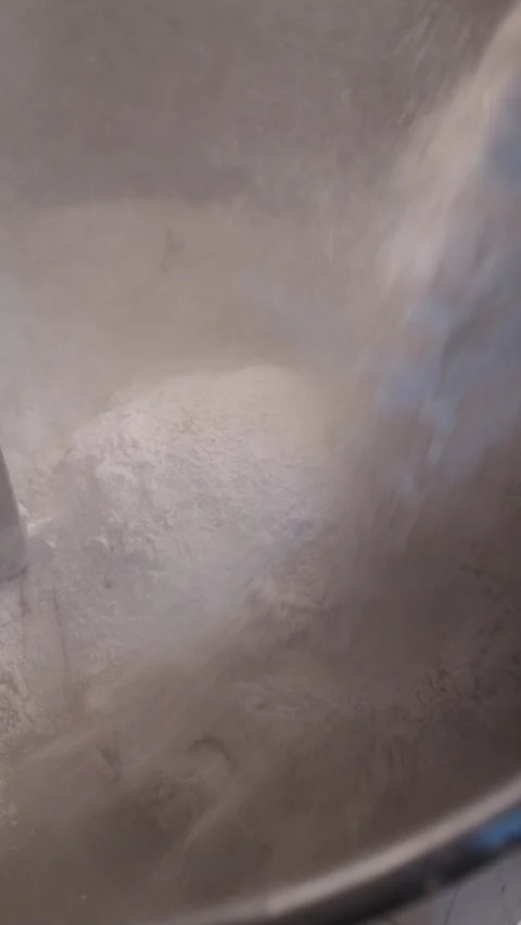 Adding Flour to Dough in an Industrial Mixer Stock Footage 345062352