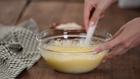 Adding flour to the dough. Process of preparation cake batter. Video stock 139357038