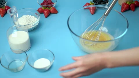 Adding flour, eggs, oil, milk, salt, sugar into a mixing glass bowl. Video stock 133592092