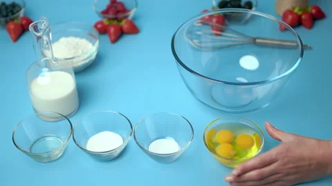 Adding flour, eggs, oil, milk, salt, sugar into a mixing glass bowl. Video stock 133592991