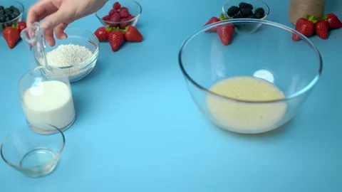 Adding flour, eggs, oil, milk, salt, sugar into a mixing glass bowl. Video stock 133593320