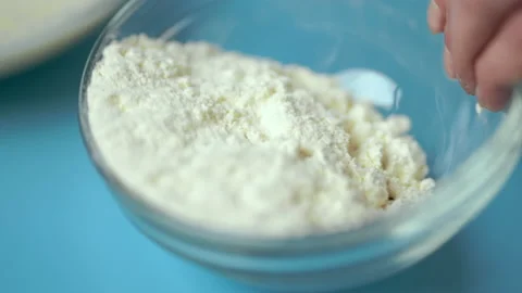 Adding flour, eggs, oil, milk, salt, sugar into a mixing glass bowl. Video stock 133594991