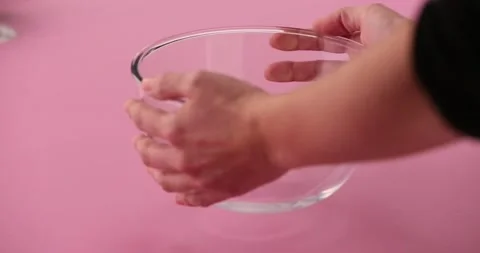Adding flour to a glass bowl Stock Footage 132147382