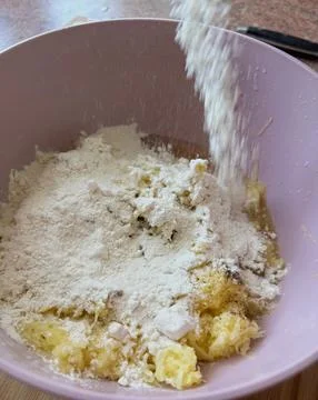 Adding flour to homemade potato pancake batter. Stock Photos