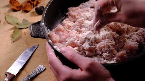 Adding flour to the minced chicken Stock Footage 87555353