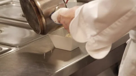 Adding food into a bowl Stock Footage 307339974