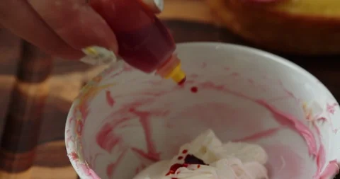 Adding food coloring to frosting Stock Footage 117018322