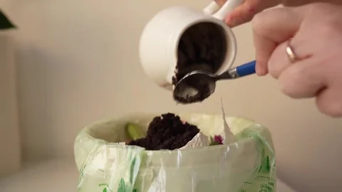 Adding Food Scraps to Kitchen Compost Bin Stock Footage 297736999