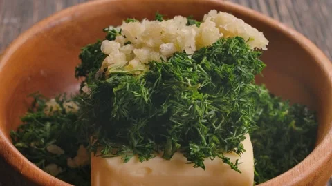 Adding Fresh Chopped Garlic to Make Herb Butter Stock Footage 316914660