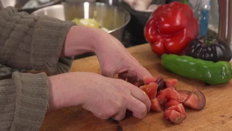 Adding fresh chopped tomatoes to a salad bowl Stock-Footage 331218556