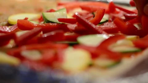 Adding Fresh Cut Red Peppers onto a Pizza  Stock Footage 130354160