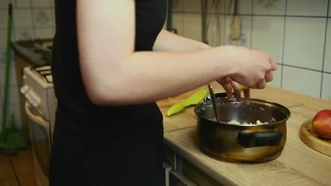 Adding fresh ingredients into cooking pot in kitchen Stock Footage 340078058