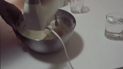 Adding Fresh Milk To Eggs In A Stainless Bowl Being Beaten With A Hand Stockbeeldmateriaal 140610550
