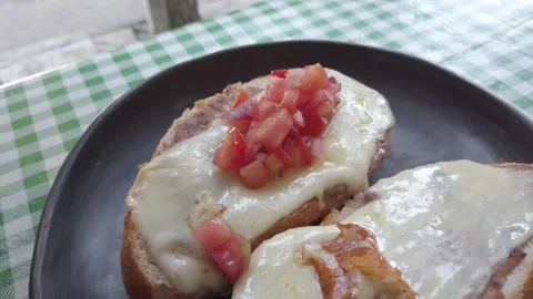 Adding Fresh Pico de Gallo Salsa to Mexican Molletes Stock Footage 324783775