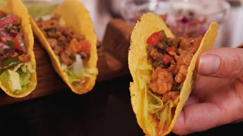 Adding the fresh salsa vegetables mix to tacos - close up Stock-Footage 131930124