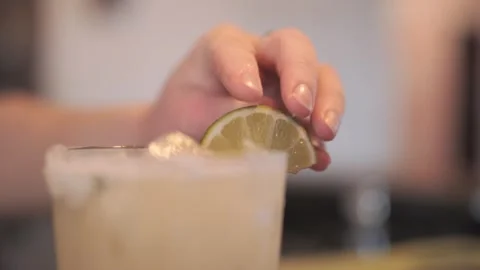Adding a Fresh Slice of Lime to a Margarita Glass 스톡 동영상 305021922