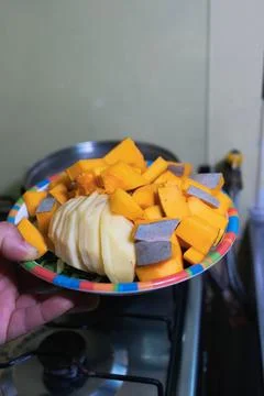 Adding fresh vegetables to a pot of soup Stock Photos