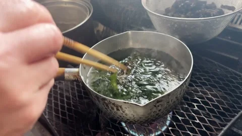 Adding Fresh Wakame Seaweed into a Pot of Boiling Water, Japanese Cooking, Japan Stockbeeldmateriaal 340868193