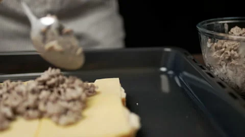 Adding fried ground beef on bread rolls in slow motion. Stock Footage 135463616