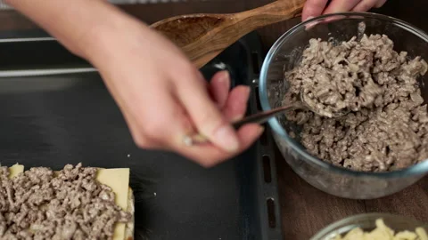 Adding fried ground beef on bread rolls in slow motion. Stock Footage 135463725