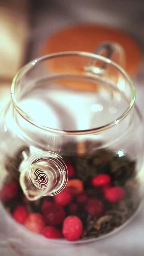 Adding Frozen Cranberries to Glass Teapot with Loose Tea Stock Footage 344043770