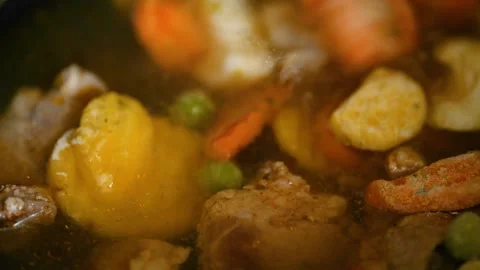 Adding frozen vegetables into boiling meat broth 스톡 동영상 336684978