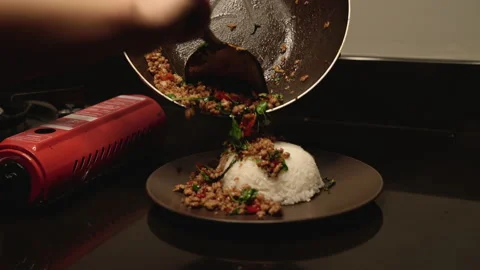 Adding frying minced pork on rice medium shot Stock Footage 150473527
