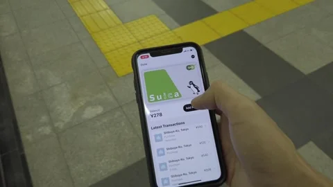 Adding funds to Suica via Apple Wallet on iPhone Stock Footage 253197814