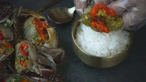 Adding Ganjang Gejang over White Rice – Korean Seafood Food Scene 動画素材 334832871
