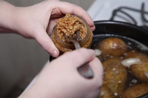 Adding Garlic to Potatoes Stock Photos